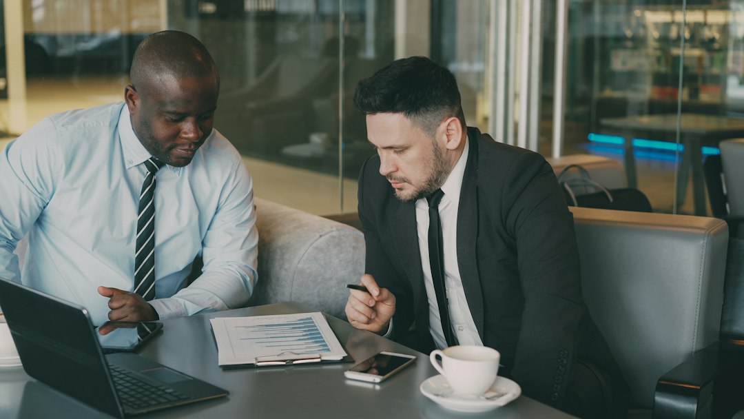 Two business professionals reviewing financial charts together