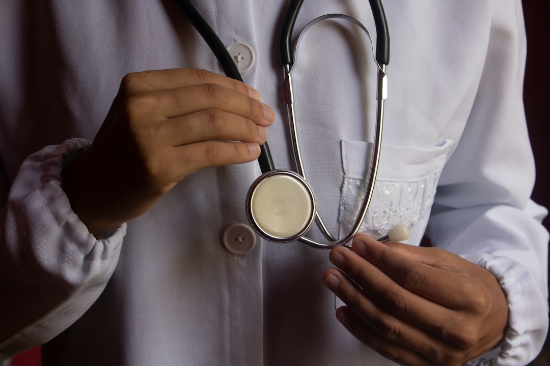 Physician in a white coat holding a stethoscope
